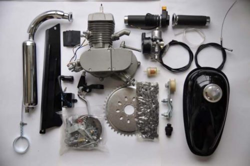 A table with many different parts of an engine.