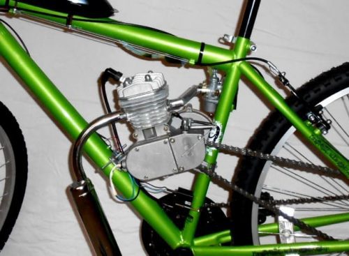 A close up of the front wheel on a green bicycle.