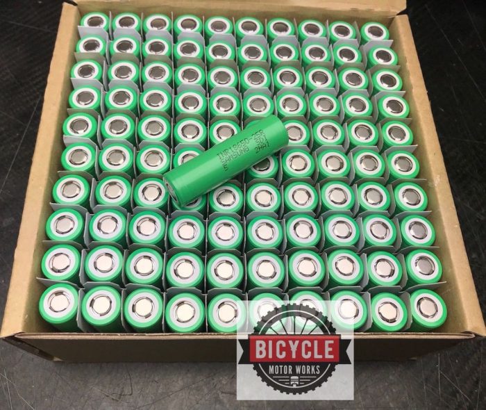 A box of batteries that are green and have been opened.