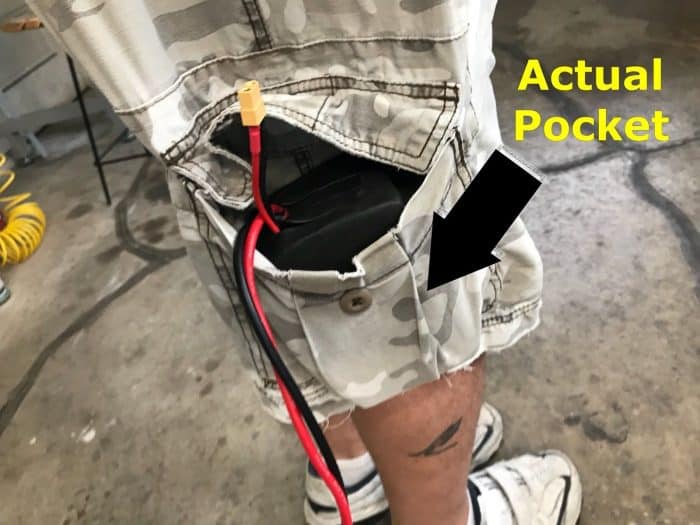 A person with an electrical cord in their pocket.