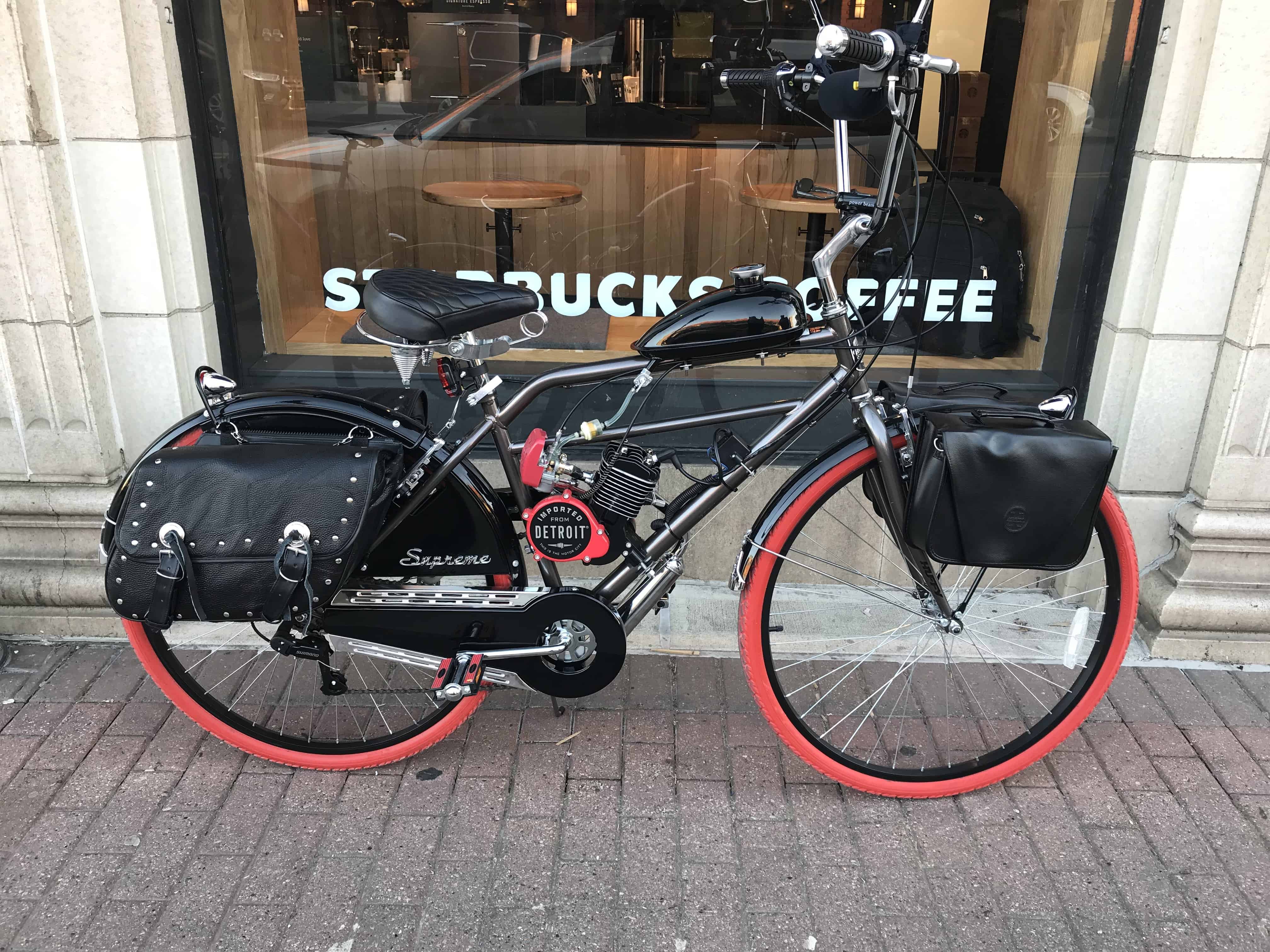 A red and blue logo for bicycle motor works.