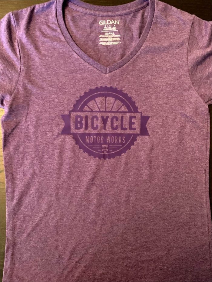 A purple shirt with the word bicycle on it.