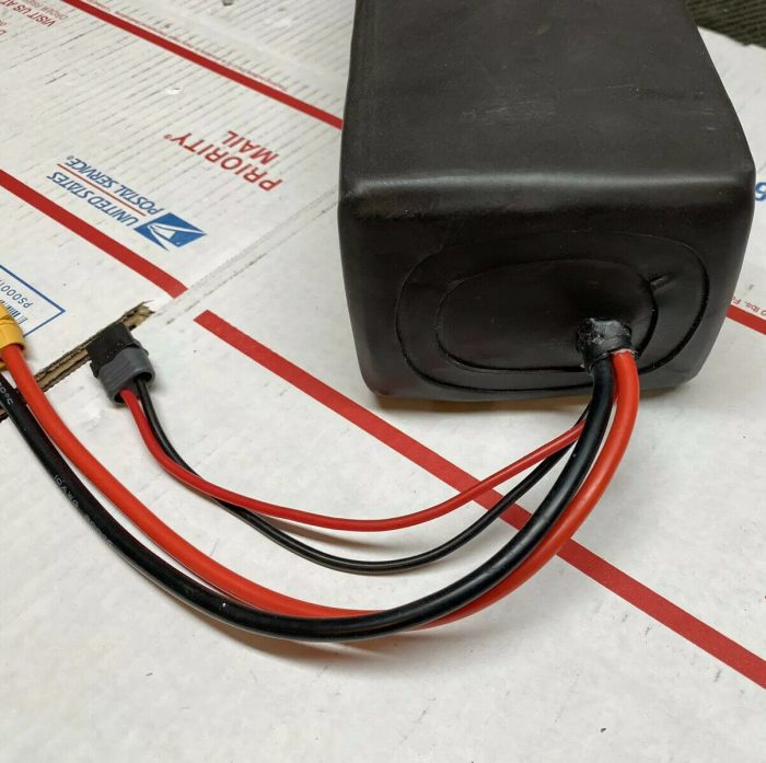 A black box with wires attached to it.