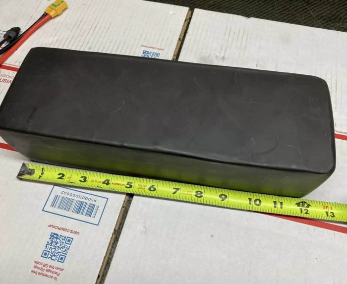 A box with a ruler and tape measure on top of it.