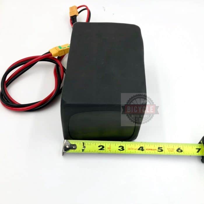 A black box with a yellow measuring tape around it