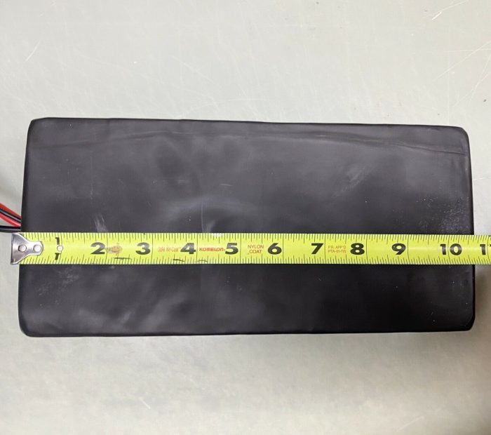 A black wallet with a yellow measuring tape on it.