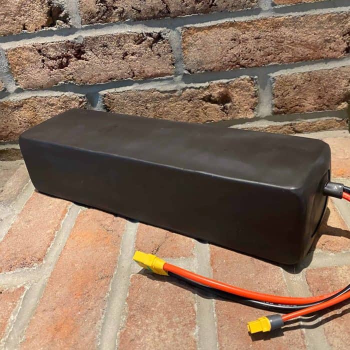 A black box sitting on top of the brick floor.