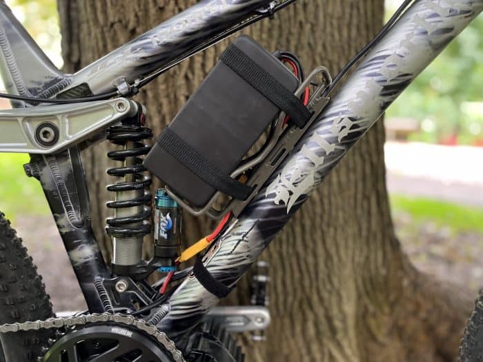 A bicycle with a cell phone attached to it.