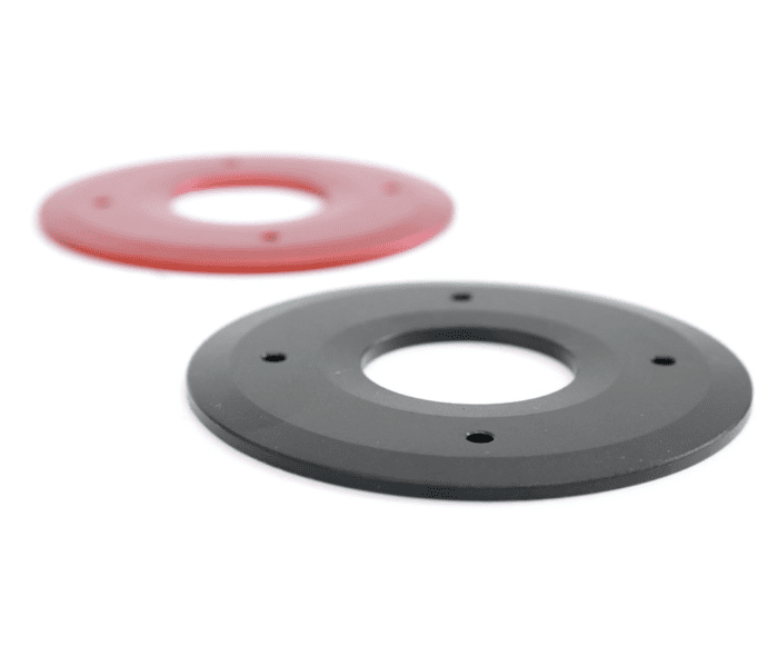 Two black and one red plastic discs on a white background