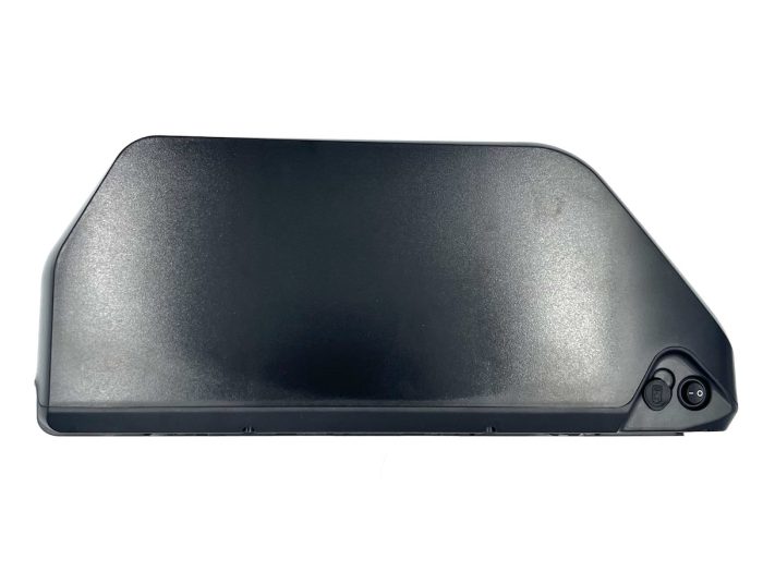 A black plastic object sitting on top of a white table.